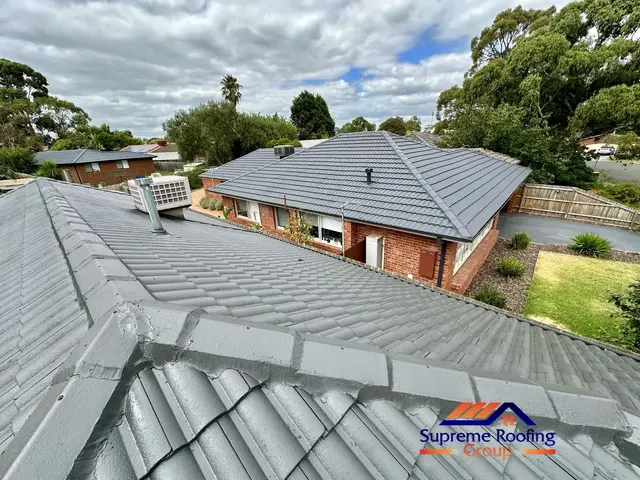Repointed ridge caps finished in Monument on a Bentleigh East roof