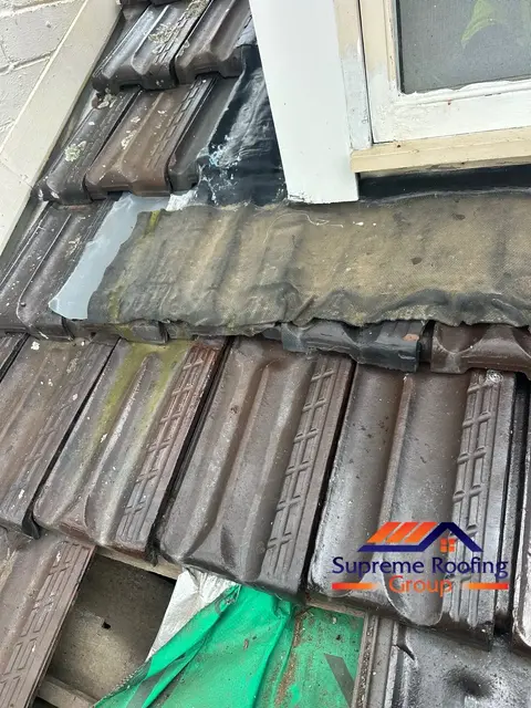 Patched wall and window junction flashing before replacement in Canterbury
