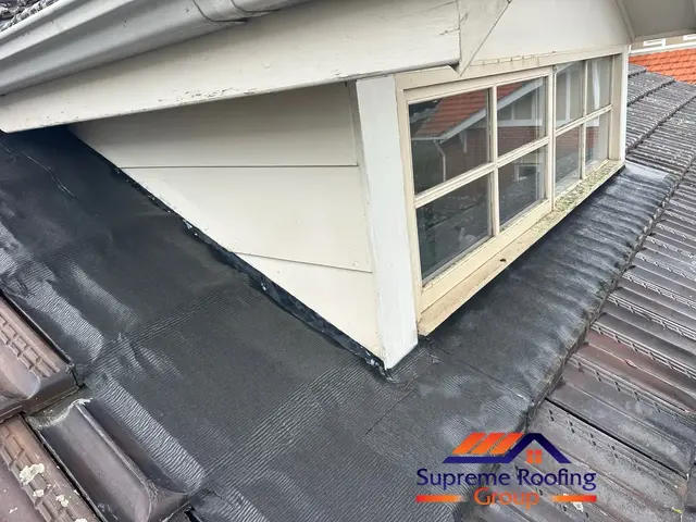 Completed wall-to-tile apron flashing replacement on a Canterbury terracotta roof