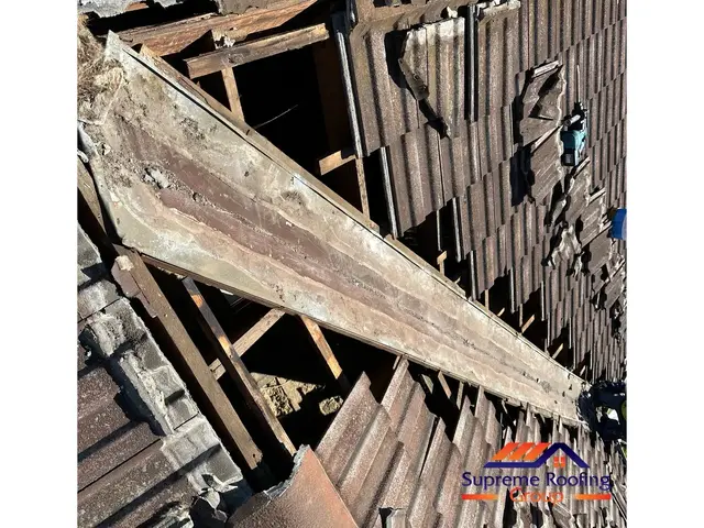 Roof tiles lifted and old valley exposed for replacement in Clayton