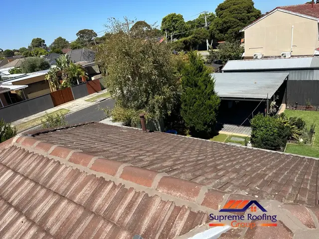 Disturbed ridge capping re-bedded and repointed after valley replacement in Clayton