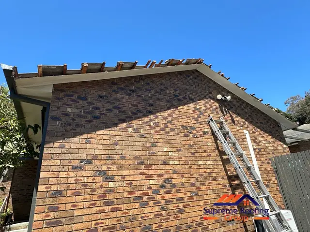 Roof tiles lifted for fascia and scotia board replacement on the left gable in Croydon Hills