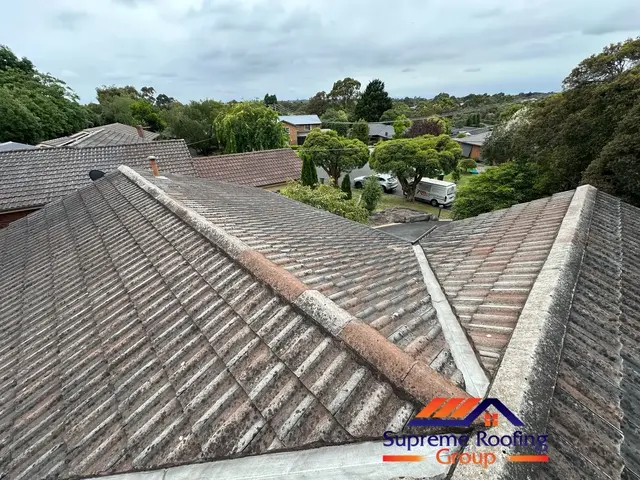 Faded cement tiles and weathered ridge work before restoration in Croydon Hills