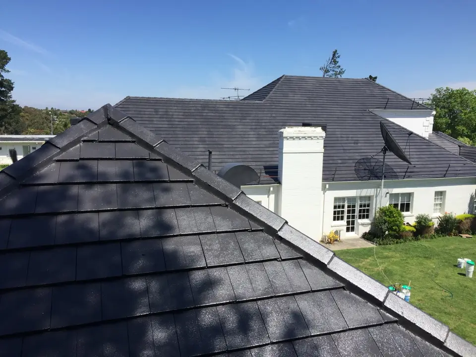 Restored charcoal roof tiles and ridge capping after coating in Templestowe