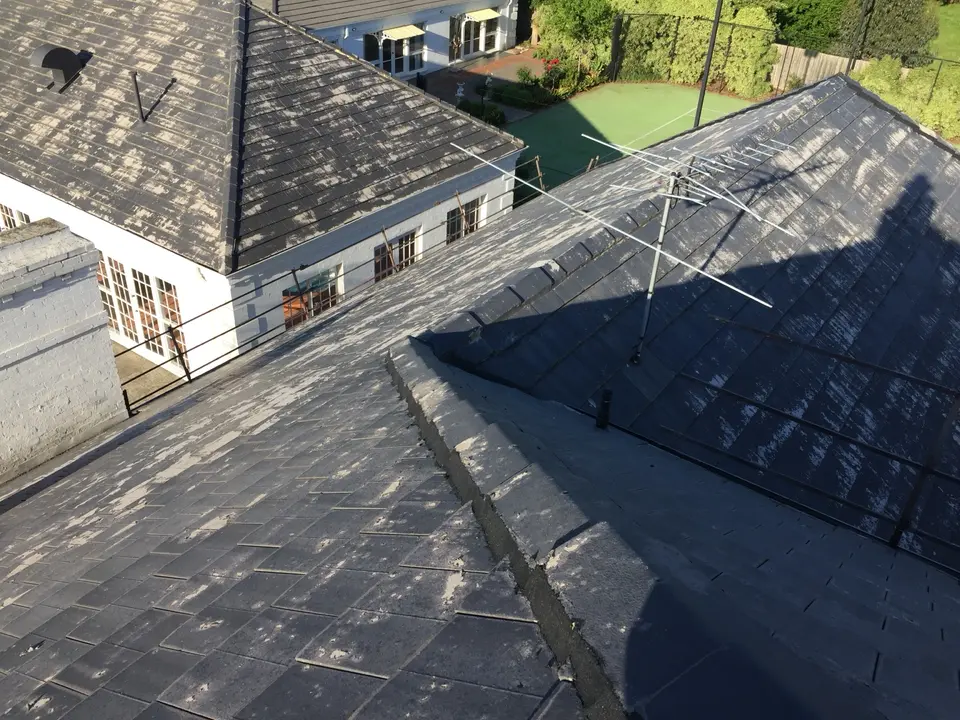 Weathered cement tiles and ridge lines during roof preparation in Templestowe
