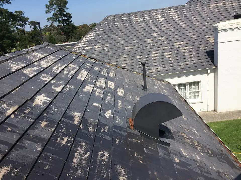 Close view of flaking old coating on cement roof tiles before preparation in Templestowe