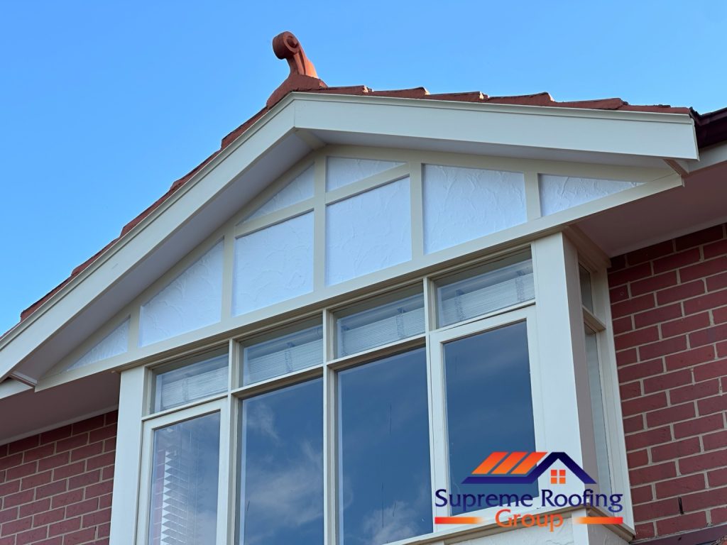 Finished terracotta roof gable above the windows, viewed from below