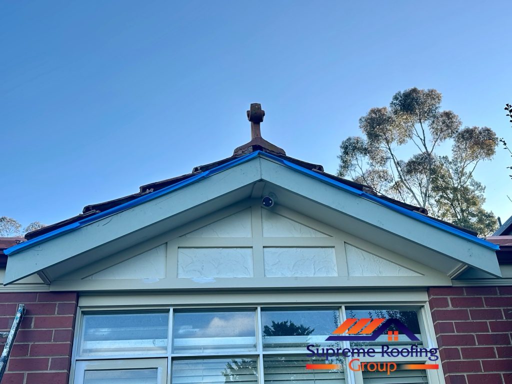 Front view of the gable with exposed roof-edge gaps and masking tape before finishing