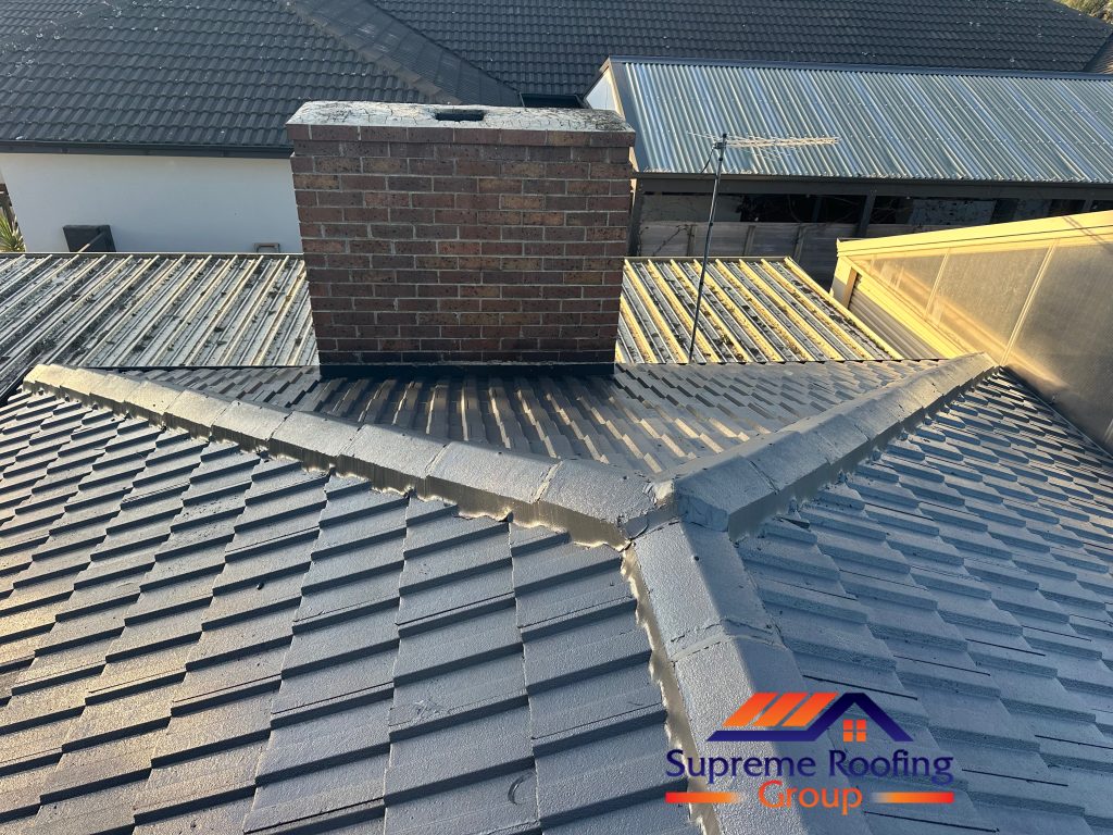 Finished Monument roof coating across the hip junction near a brick chimney in Rowville
