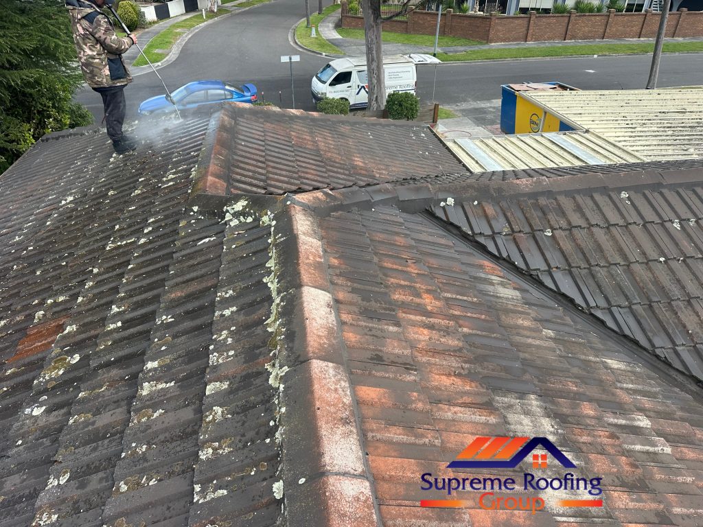 Pressure cleaning in progress on the weathered Rowville tiled roof