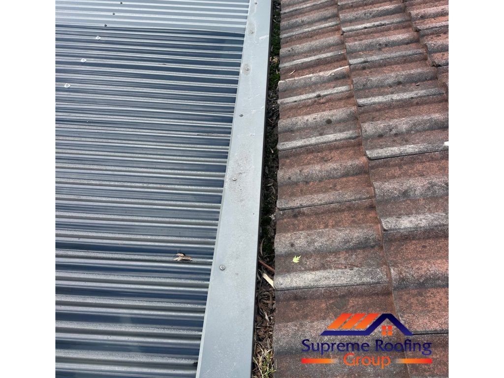 Leaves and debris in a narrow gutter beside the Croydon Hills tiled roof