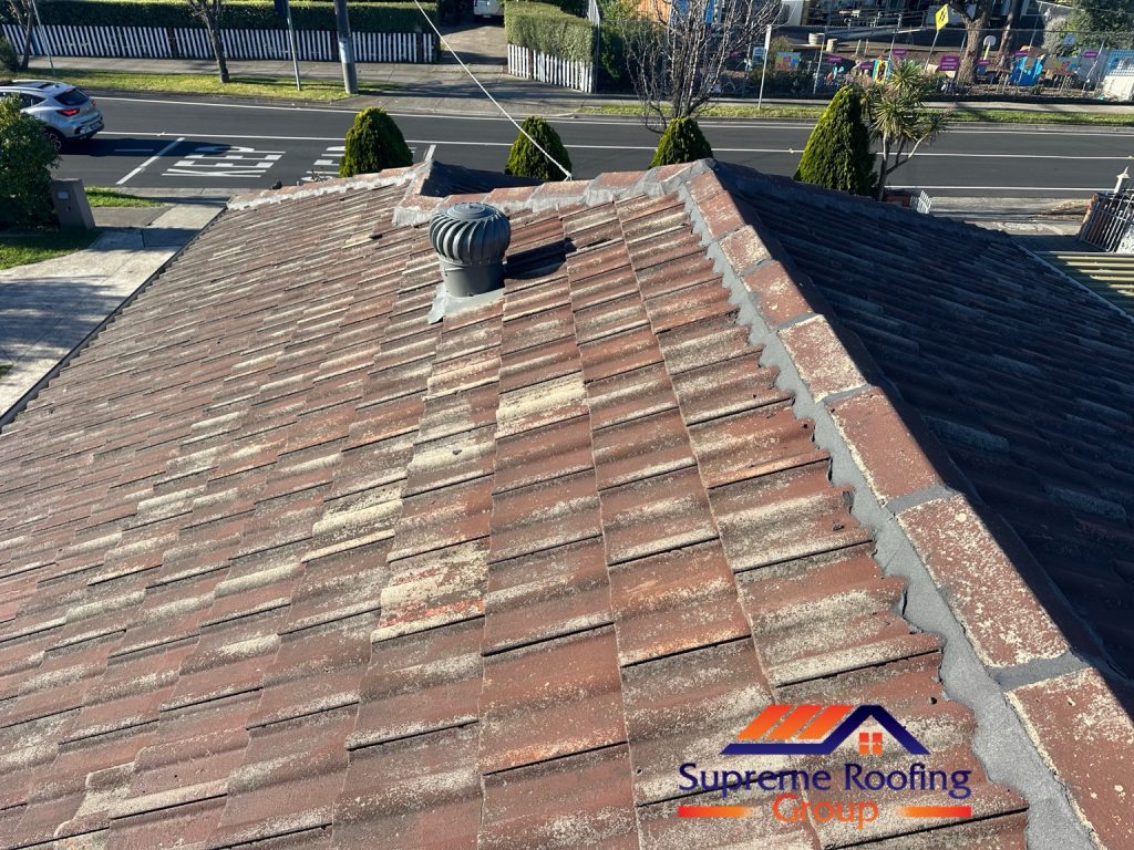 Repointed hip caps beside a roof ventilator on the Thomastown tiled roof